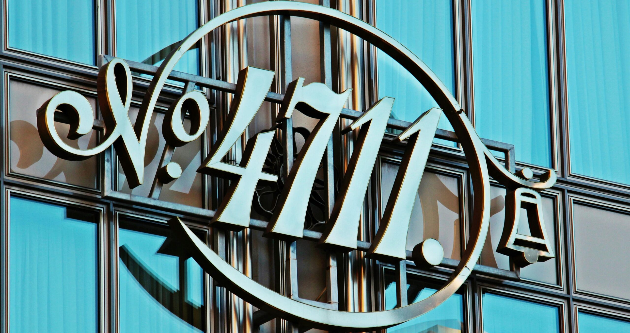 No. 4711 cologne logo on a contemporary glass facade, combining modern and vintage elements.