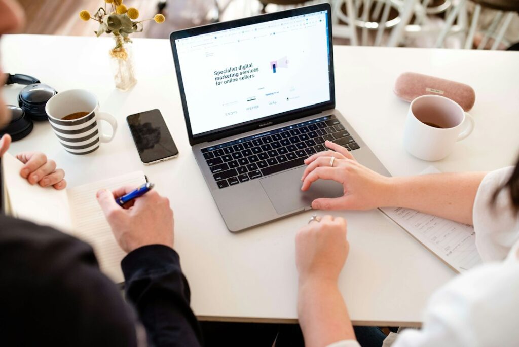 Two marketers reviewing social media strategy and reporting together